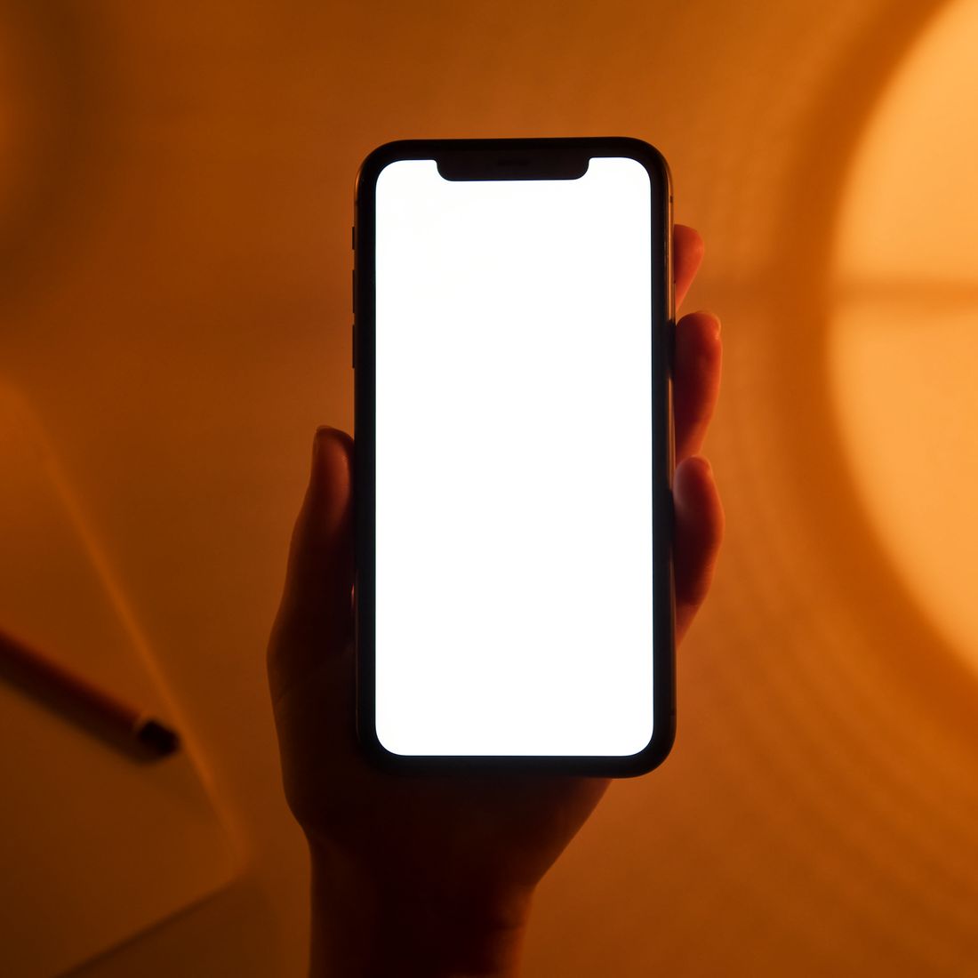A hand holding a phone running a local-first app